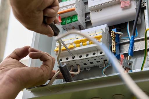 Squeak's electrician working on electrical panel.